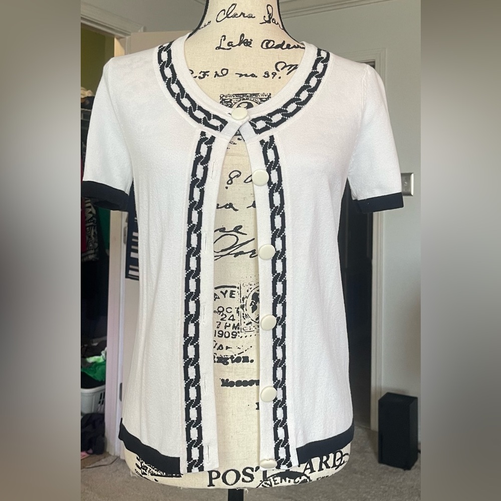 A lovely white with black trim cardigan sweater, short sleeve size medium
